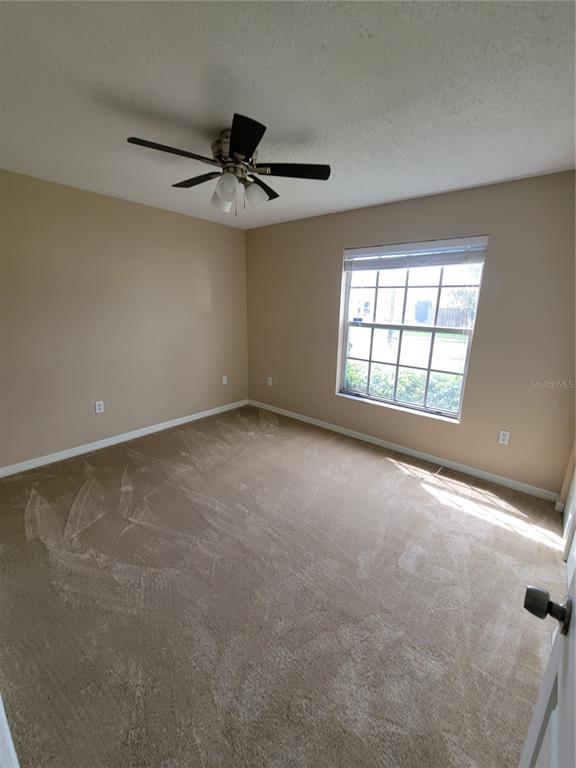 7401 Jenner Avenue New Port Richey, FL 34655 - Photo 10 of 14 an empty room with a window and a ceiling fan