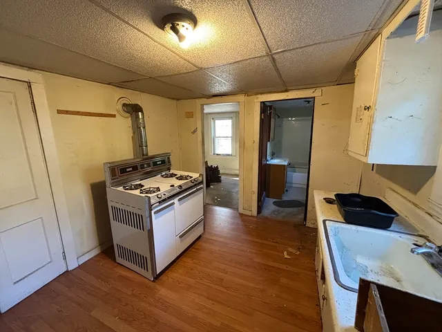 a kitchen with stainless steel appliances granite countertop a stove and a refrigerator