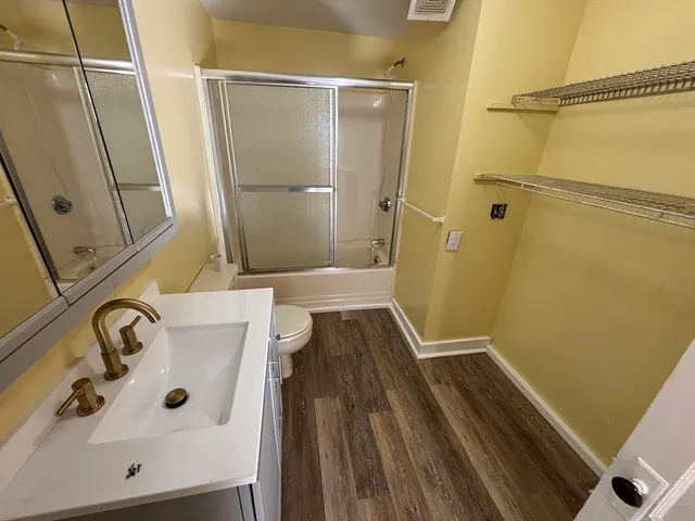 a bathroom with a sink and glass door shower