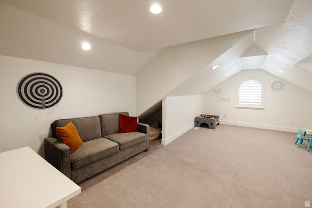 924 Country Lane Farmington, UT 84025 - Photo 45 of 91 Spacious bonus room featuring an arched window with louvered shutters, sloped ceilings, recessed lighting, and neutral-toned carpeting
