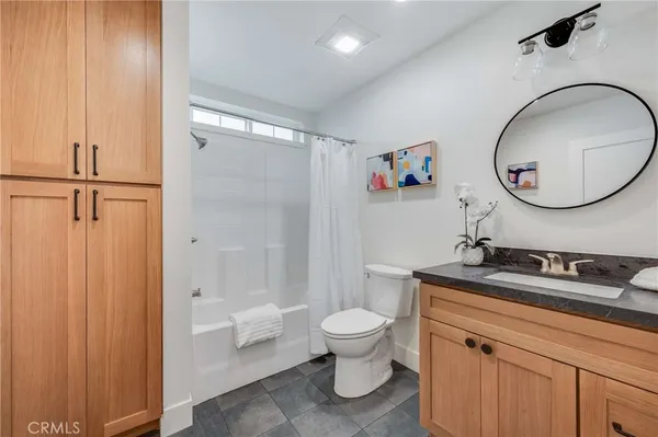 a bathroom with a toilet a sink and a mirror