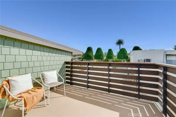 a view of a two chairs in the balcony