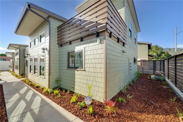 a view of a street with potted plants