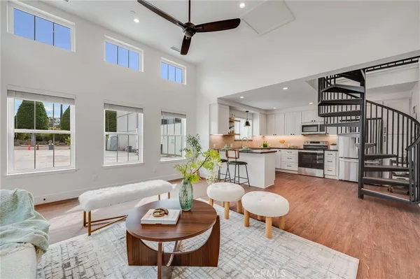 a living room with furniture a wooden floor and a window