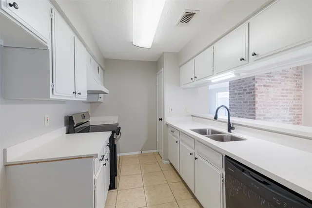 a kitchen with a sink cabinets and appliances