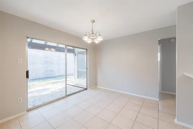 a view of an empty room with glass door