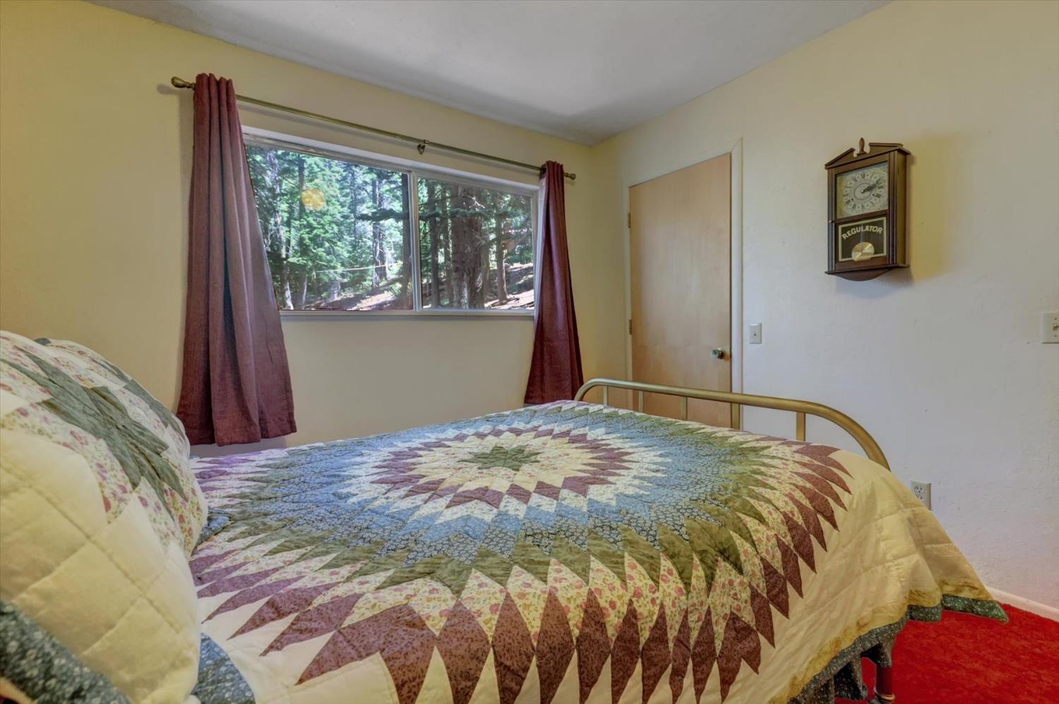 351 Silver Tip Springs Road Strawberry Valley, CA 95981 - Photo 18 of 57 a bed sitting in a bedroom next to a window
