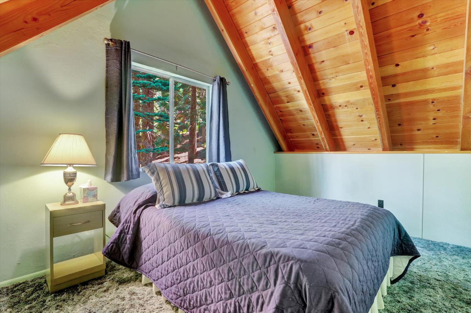 351 Silver Tip Springs Road Strawberry Valley, CA 95981 - Photo 19 of 57 a bed sitting in a bedroom next to a window