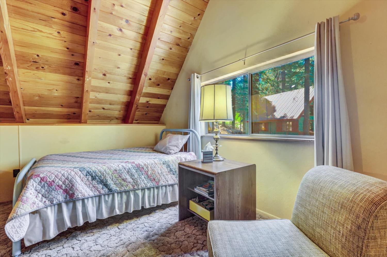 351 Silver Tip Springs Road Strawberry Valley, CA 95981 - Photo 23 of 57 a bedroom with a bed window and painting on the wall