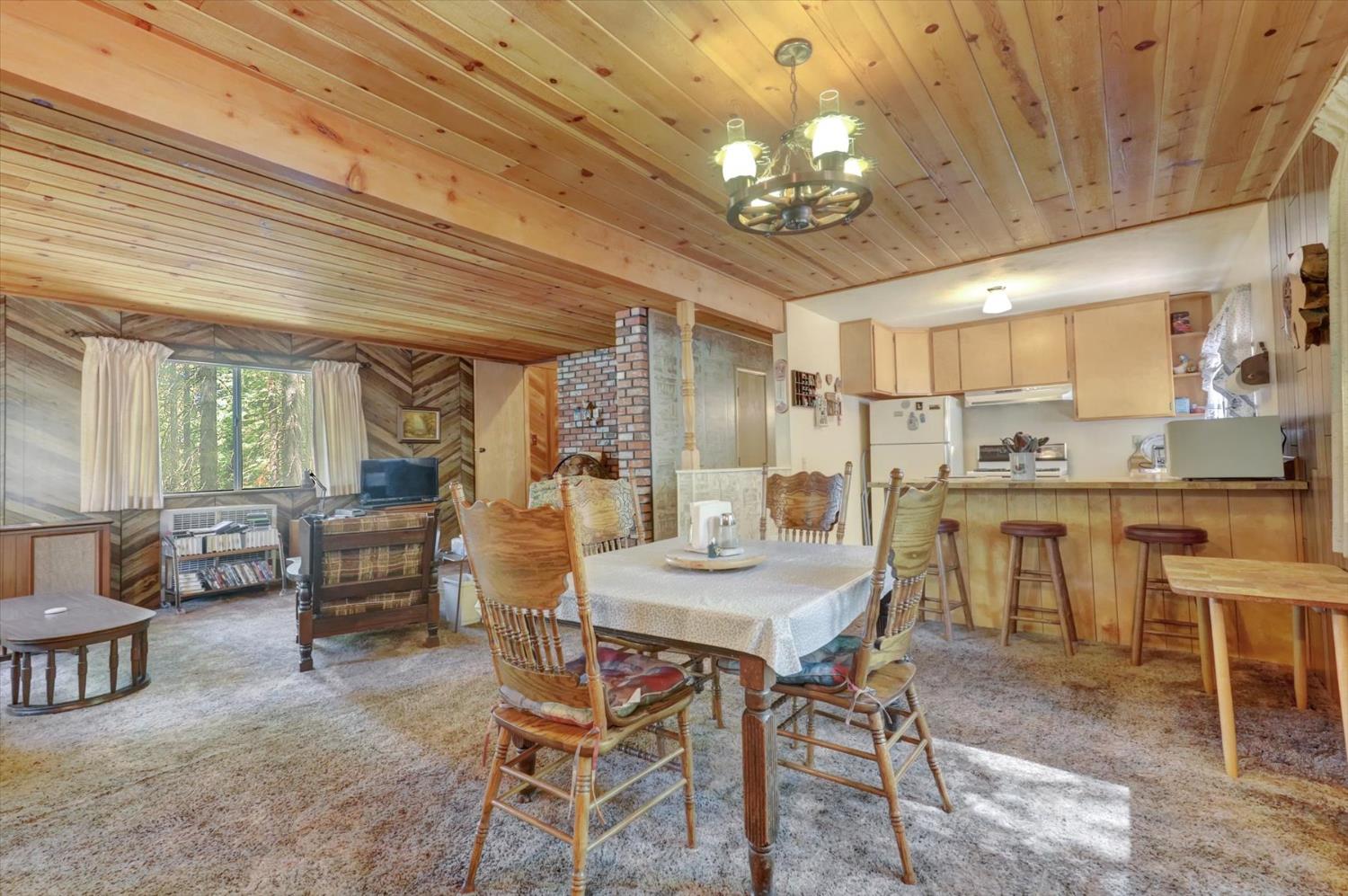 351 Silver Tip Springs Road Strawberry Valley, CA 95981 - Photo 5 of 57 a kitchen with a dining table chairs sink and granite counter tops