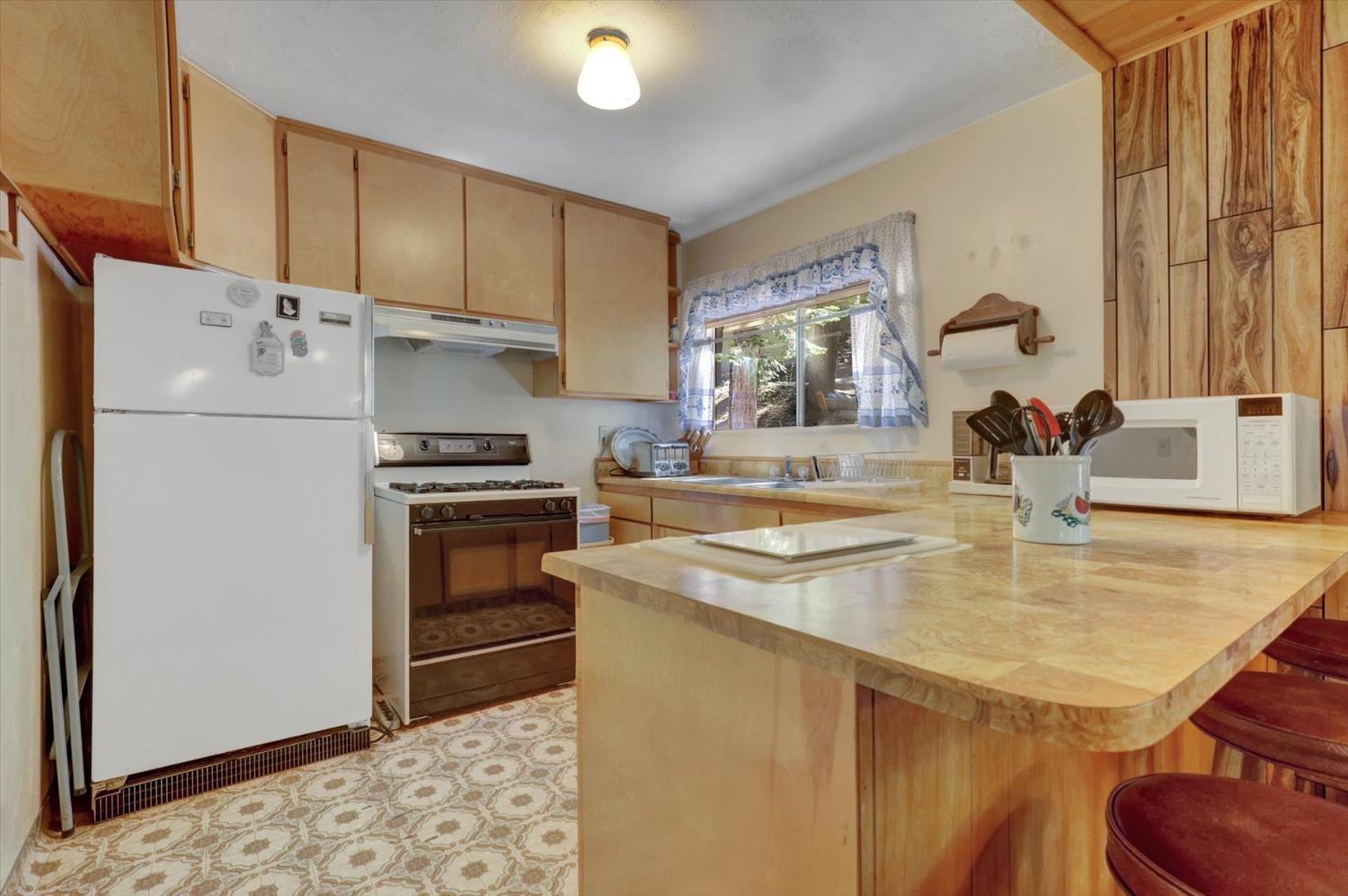 351 Silver Tip Springs Road Strawberry Valley, CA 95981 - Photo 6 of 57 a kitchen with a sink a stove and refrigerator