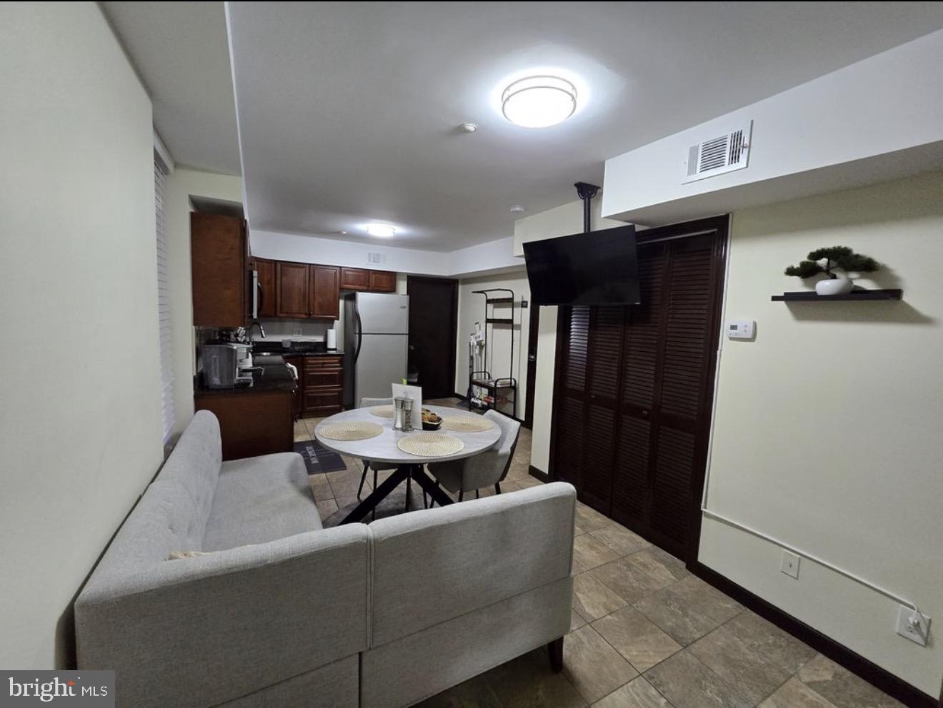 230 Market Street, Unit 4 Philadelphia, PA 19106 - Photo 3 of 10 a living room with furniture and a refrigerator