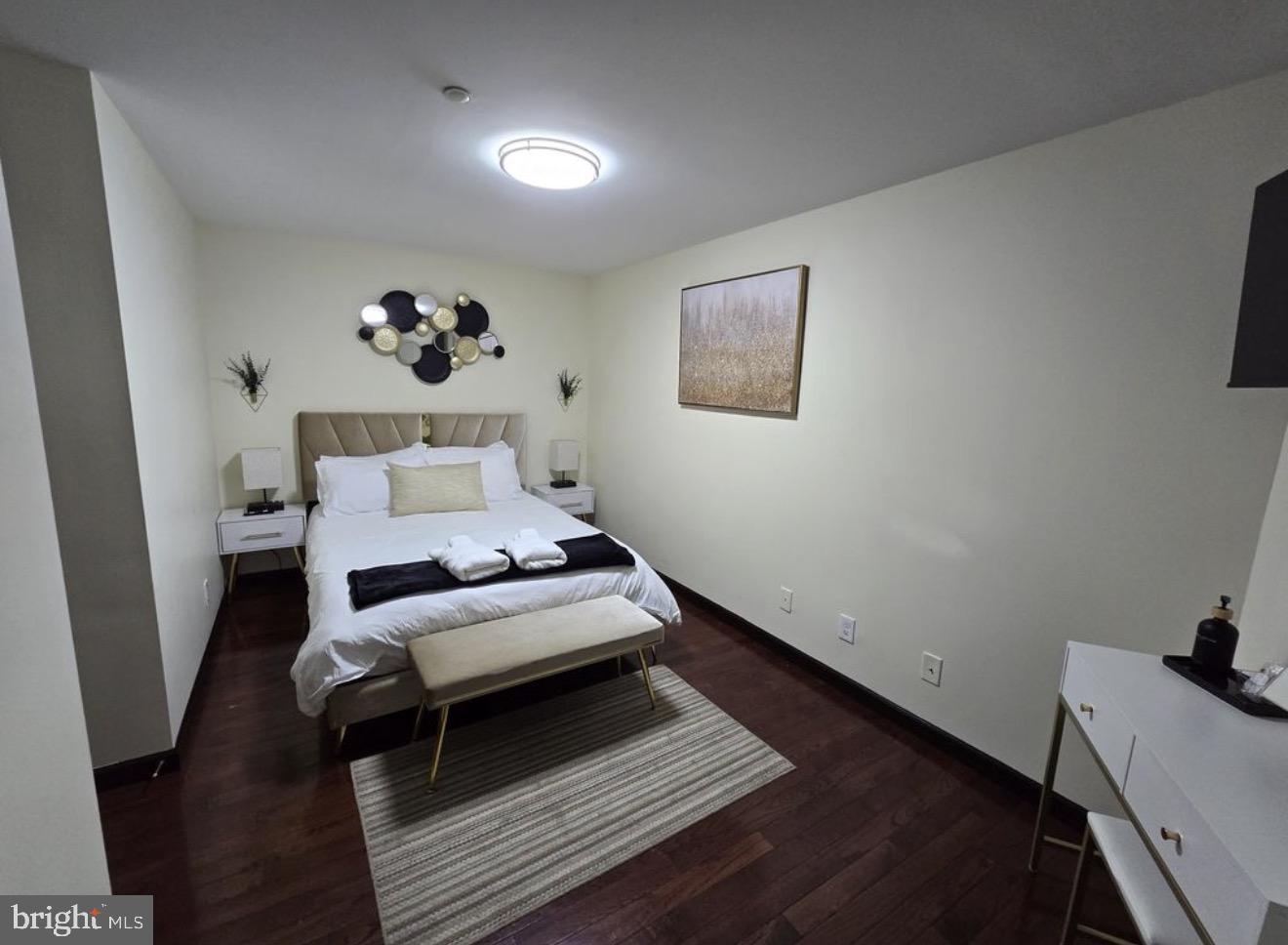 230 Market Street, Unit 4 Philadelphia, PA 19106 - Photo 8 of 10 a bedroom with a bed and wooden floor