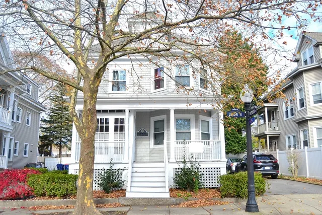a front view of a house with tree s