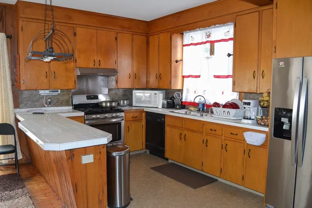 a view of a dining room with furniture and chandelier