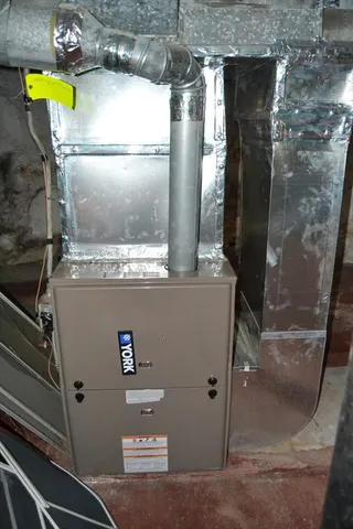 a view of walk in closet with window and refrigerator