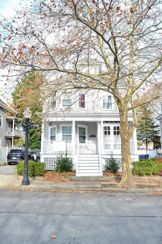 a front view of a residential apartment building with a yard