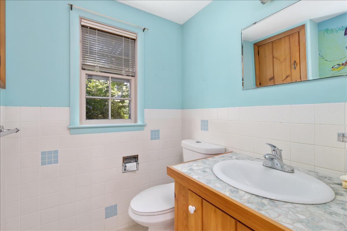 34 Scatteree Road North Chatham, MA 02650 - Photo 38 of 40 a bathroom with a granite countertop toilet sink and mirror
