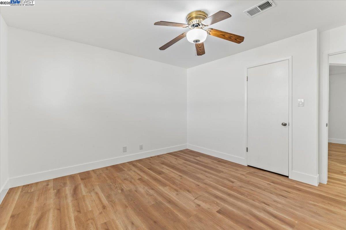 462 Craven Court Hayward, CA 94541 - Photo 31 of 50 an empty room with wooden floor and a ceiling fan