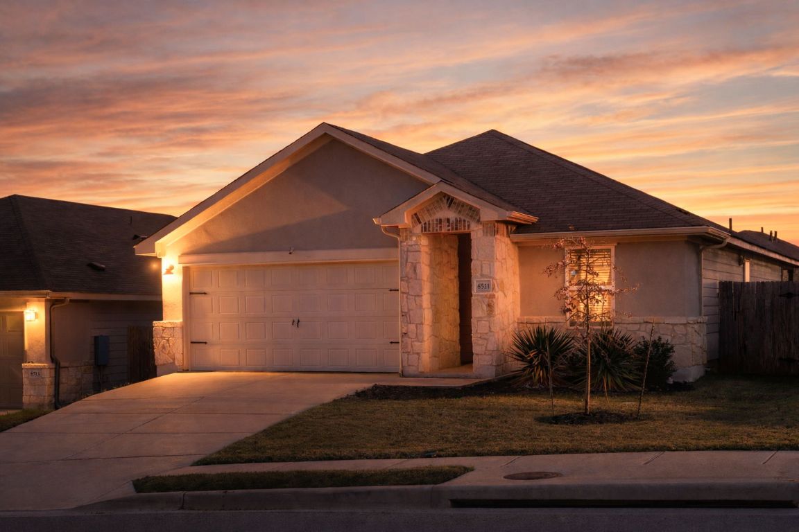 6511 Rounded Pebble Lane Buda, TX 78610 - Photo 10 of 25 View of front facade with stone siding, driveway, a garage, and stucco siding
