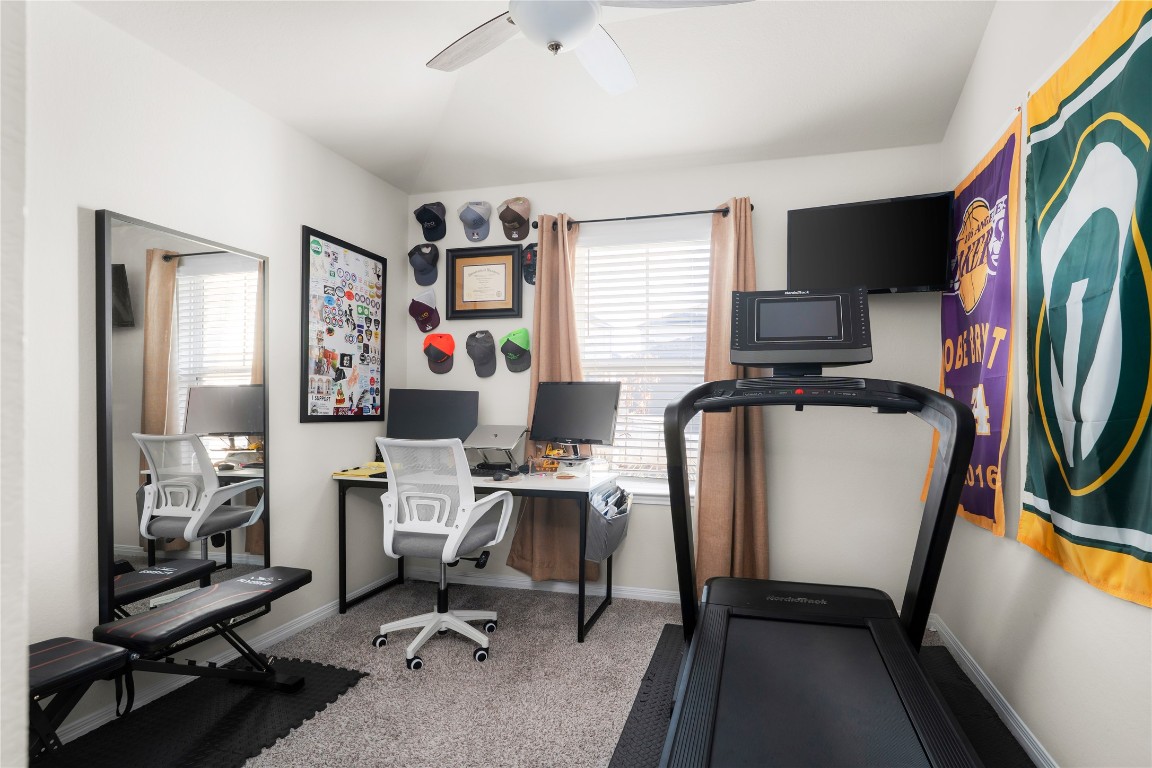 6511 Rounded Pebble Lane Buda, TX 78610 - Photo 20 of 25 Office area with light colored carpet and a ceiling fan
