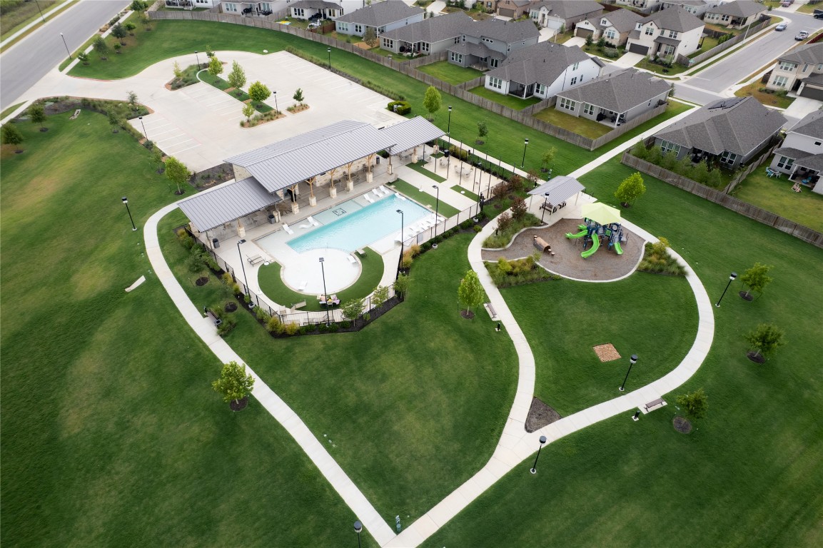 6511 Rounded Pebble Lane Buda, TX 78610 - Photo 22 of 25 Aerial view of property and surrounding area featuring a pool and nearby suburban area