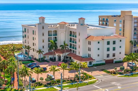 a front view of a building with outdoor seating