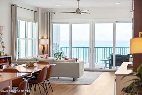 a kitchen with stainless steel appliances kitchen island granite countertop a refrigerator a stove a sink dishwasher and white cabinets with wooden floor