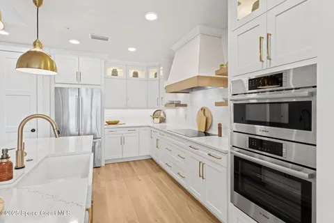 a spacious bedroom with a bed a couch and a potted plant