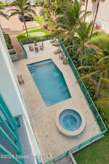 a view of swimming pool with a table and chairs