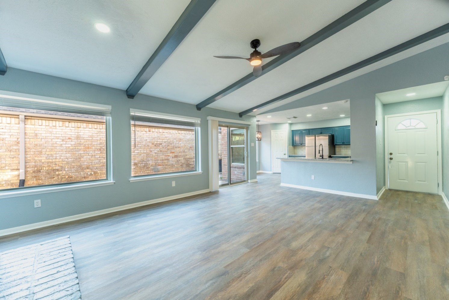 11803 Brook Meadows Lane Meadows Place, TX 77477 - Photo 1 of 17 a view of an empty room with a window and wooden floor