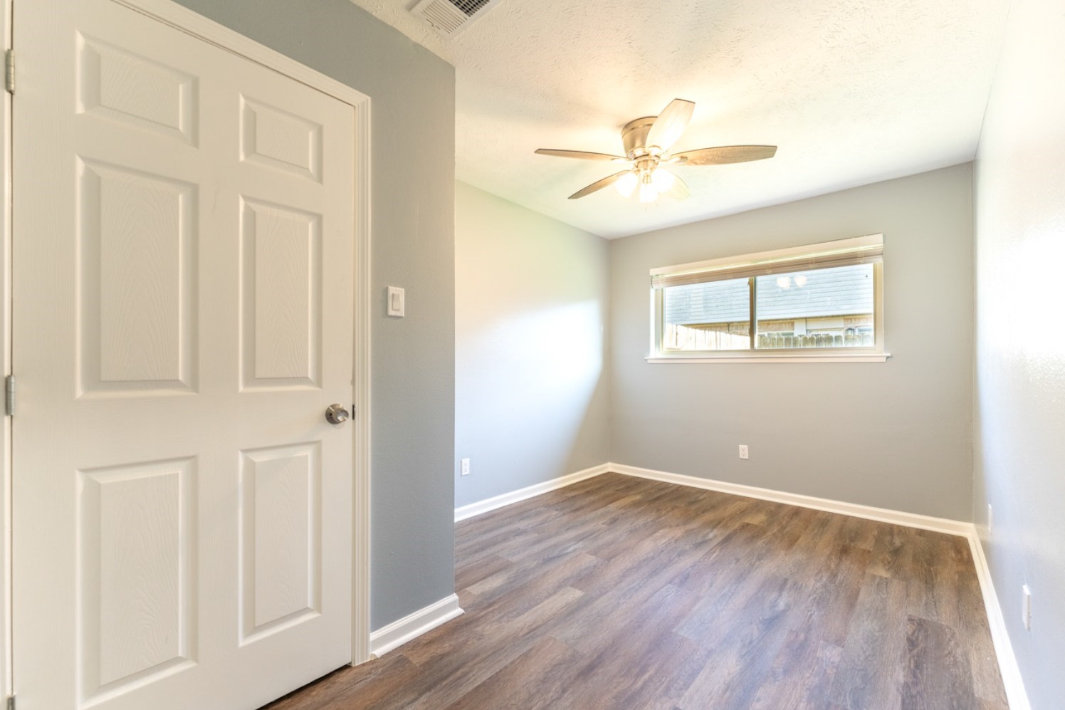 11803 Brook Meadows Lane Meadows Place, TX 77477 - Photo 15 of 17 wooden floor in an empty room with a window