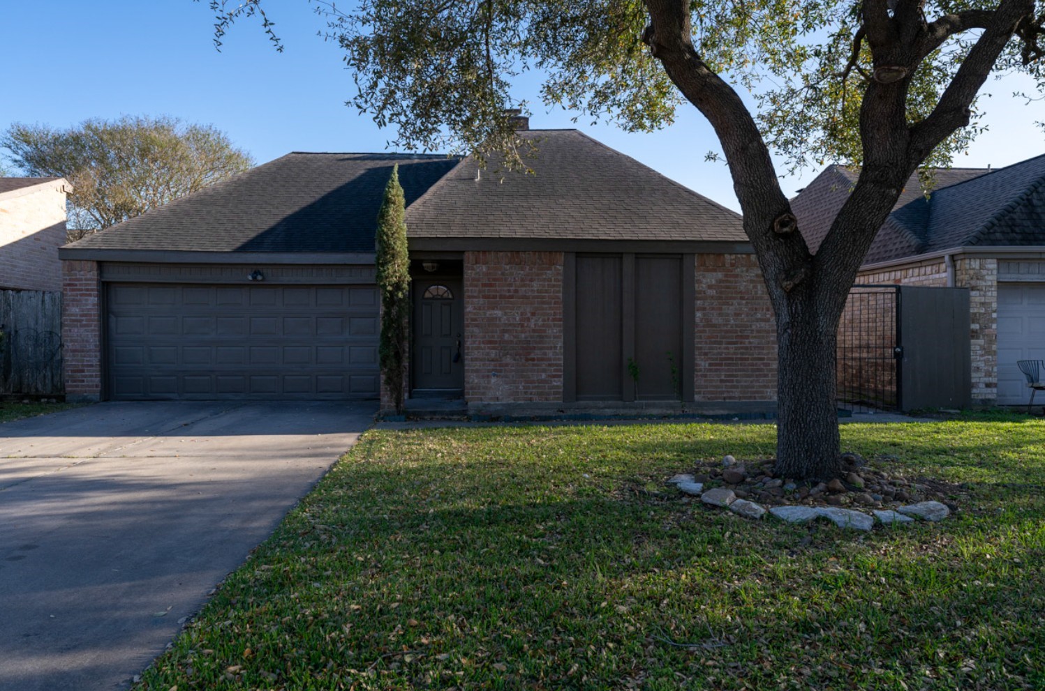 11803 Brook Meadows Lane Meadows Place, TX 77477 - Photo 2 of 17 a front view of a house with a garden and trees