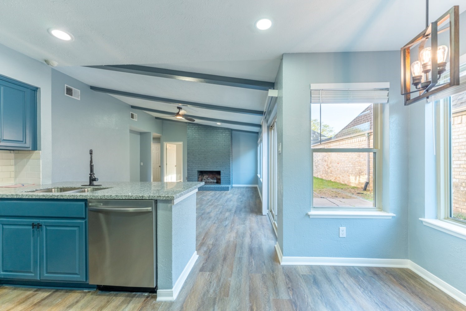 11803 Brook Meadows Lane Meadows Place, TX 77477 - Photo 5 of 17 a kitchen with granite countertop a sink and wooden floor
