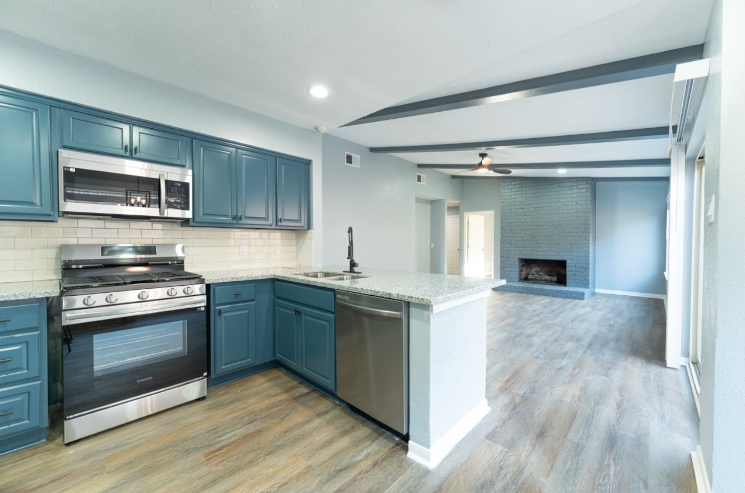 11803 Brook Meadows Lane Meadows Place, TX 77477 - Photo 6 of 17 a kitchen with a stove and a microwave
