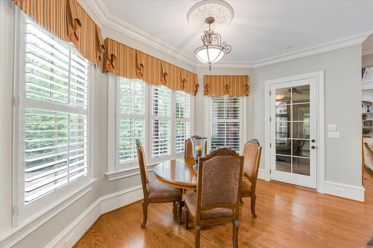 9712 Honeycutt Road Raleigh, NC 27614 - Photo 17 of 83 a view of a dining room with furniture window and wooden floor