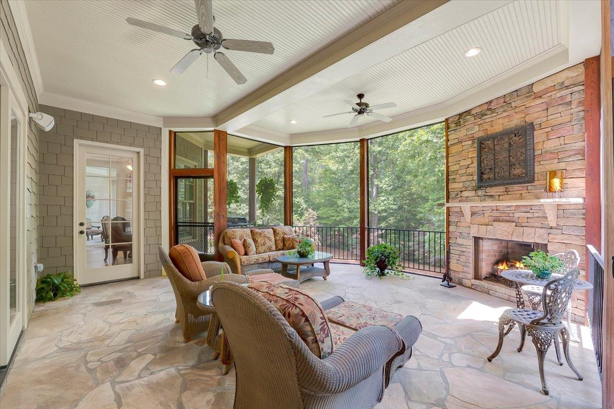 9712 Honeycutt Road Raleigh, NC 27614 - Photo 20 of 83 a living room with furniture large windows and a fireplace