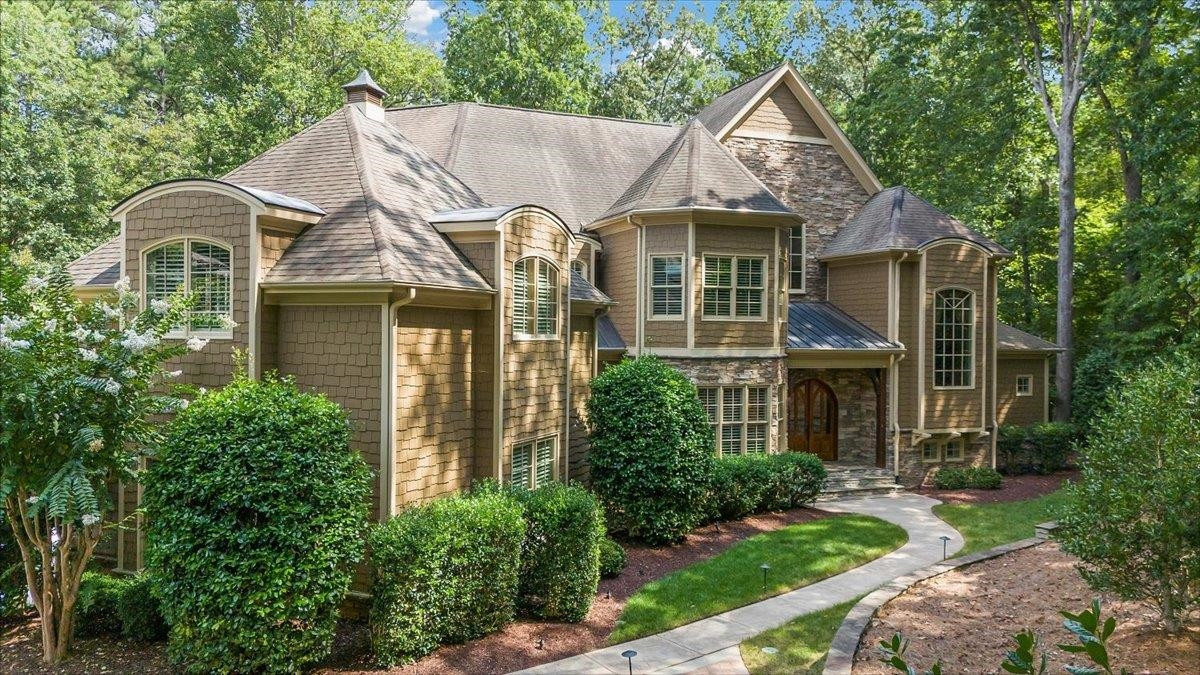 9712 Honeycutt Road Raleigh, NC 27614 - Photo 2 of 83 a view of a white house next to a yard with plants and trees