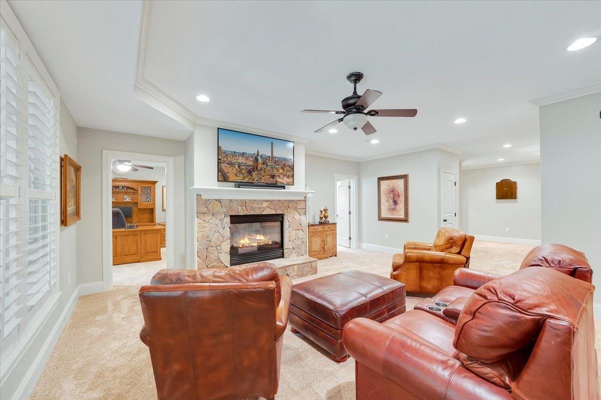 9712 Honeycutt Road Raleigh, NC 27614 - Photo 45 of 83 a living room with furniture fireplace and a flat screen tv