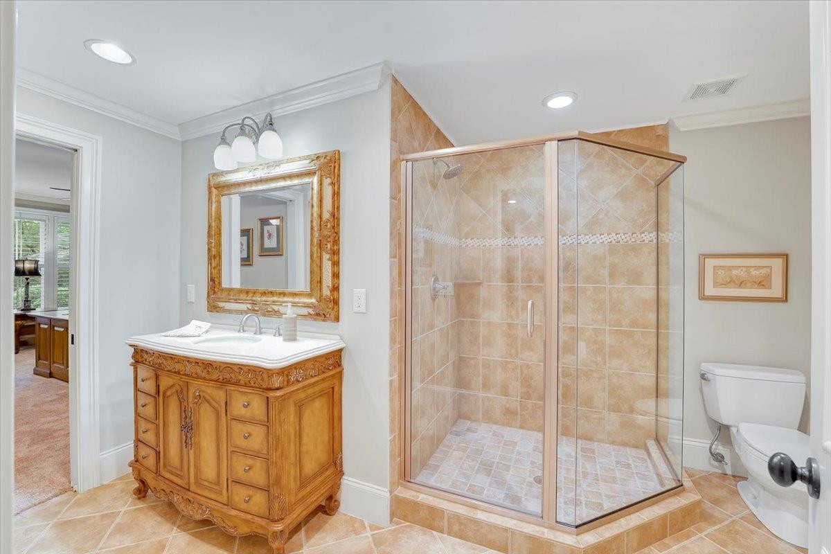 9712 Honeycutt Road Raleigh, NC 27614 - Photo 52 of 83 a bathroom with a shower a mirror and a sink