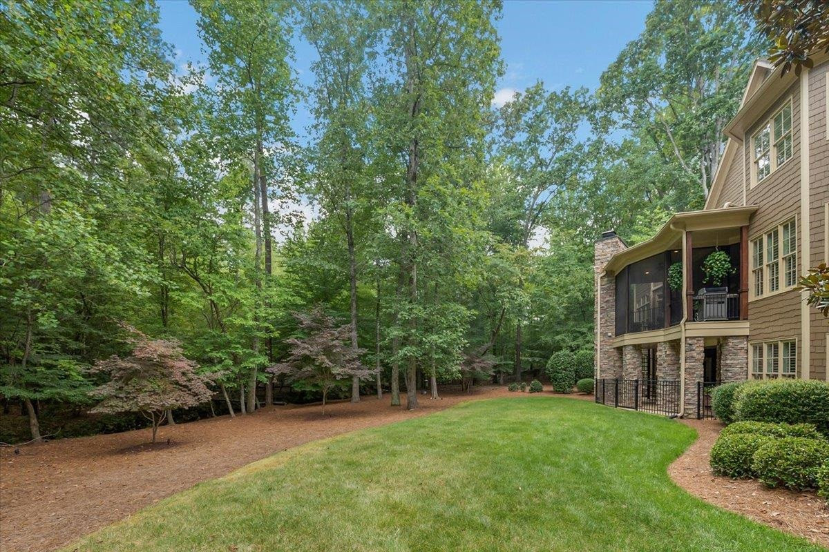 9712 Honeycutt Road Raleigh, NC 27614 - Photo 74 of 83 a view of a brick house with a big yard and large trees