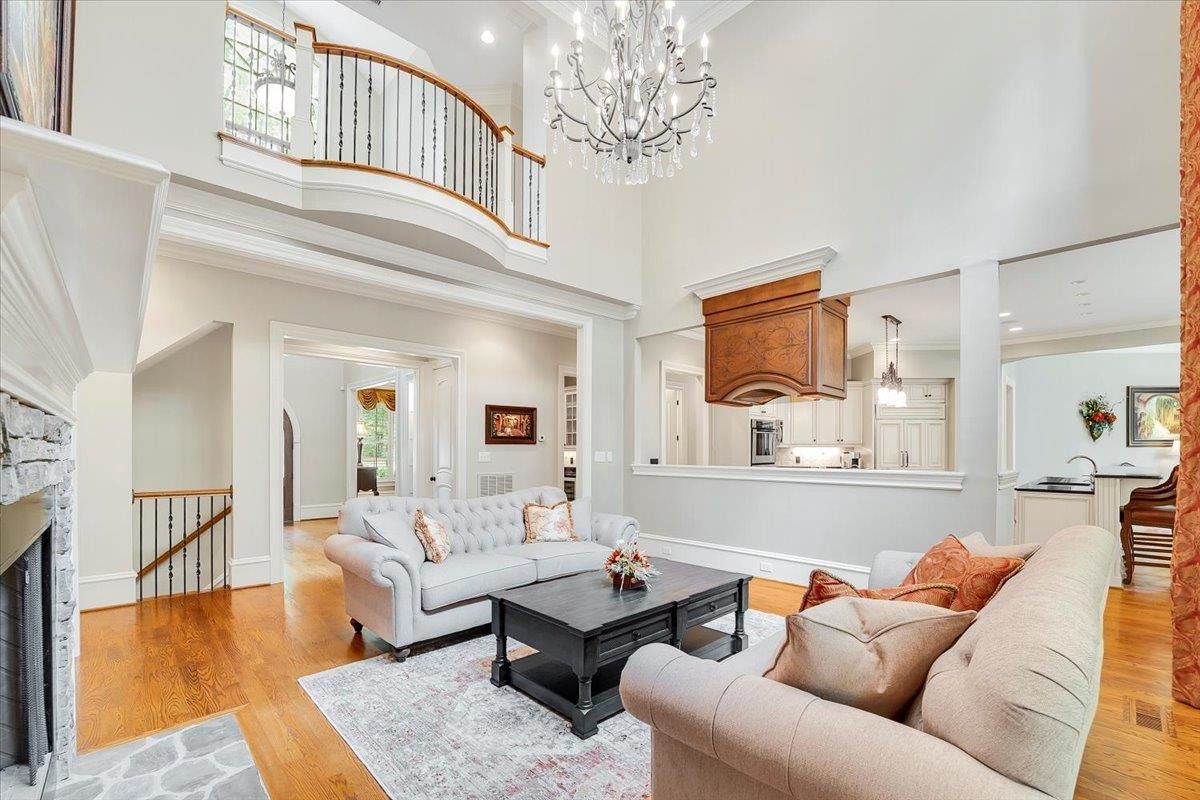 9712 Honeycutt Road Raleigh, NC 27614 - Photo 9 of 83 a living room with furniture and a chandelier