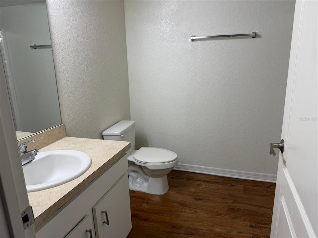 2323 McCoy Road, Unit 613 Orlando, FL 32809 - Photo 6 of 13 a bathroom with a sink a toilet and vanity