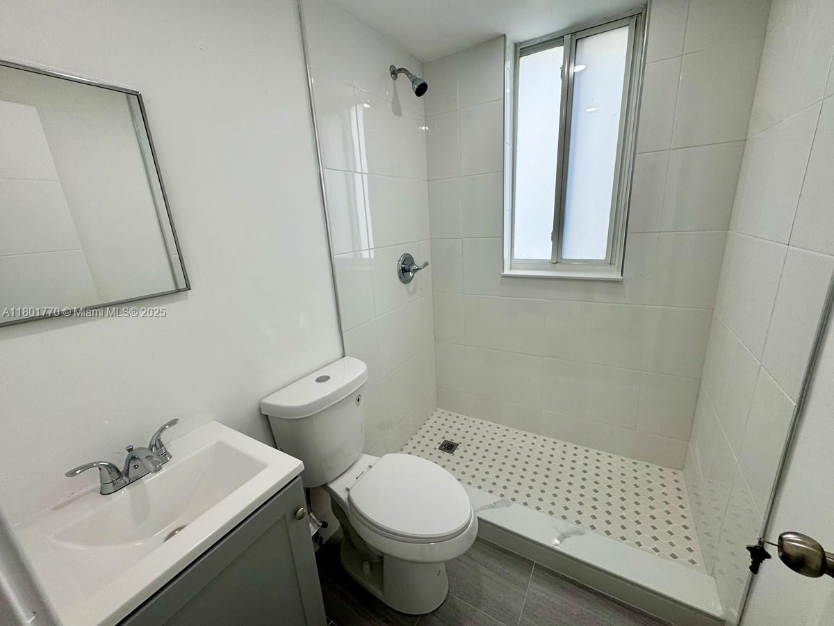 856 Southwest 6th Street, Unit 102 Miami, FL 33130 - Photo 2 of 9 a bathroom with a sink toilet and shower
