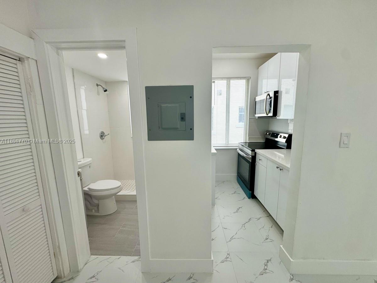 856 Southwest 6th Street, Unit 102 Miami, FL 33130 - Photo 5 of 9 a bathroom with a sink a toilet and shower