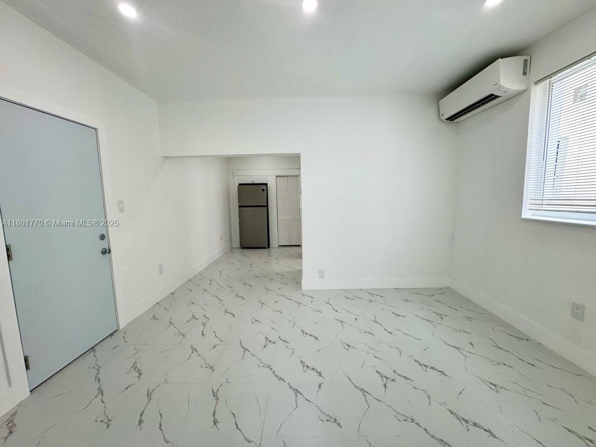 856 Southwest 6th Street, Unit 102 Miami, FL 33130 - Photo 8 of 9 an empty room with windows