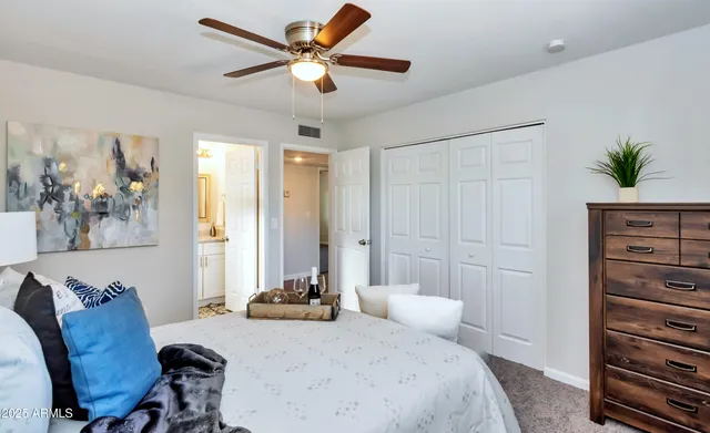 a bedroom with a bed dresser and a window