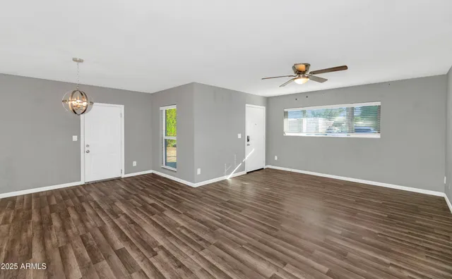 an empty room with windows and closet