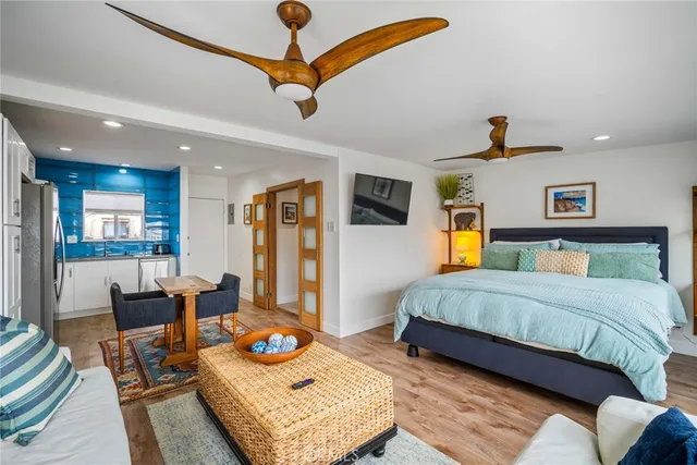 a bedroom with a bed a couch and dresser