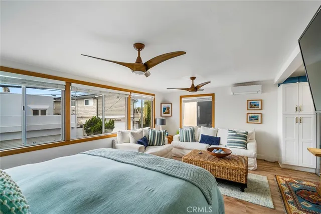 a bedroom with a large bed and a large window